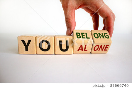 You alone or belong symbol. Businessman turns cubes and changes words you alone to you belong. Beautiful white background. Business, psychology and you alone or belong concept. Copy space. You alone or belong symbol. Businessman turns cubes and changes words you alone to you belong. Beautiful white background. Business, psychology and you alone or belong concept. Copy space. 85666740
