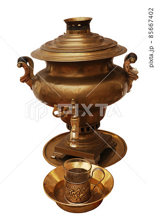 traditional Russian brass samovar and a glass in a glass holder on white 85667402