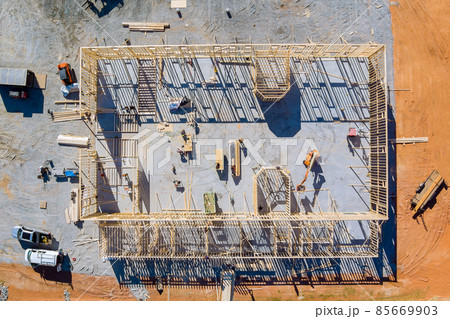 Aerial view framing of beams on new home under construction Aerial view framing of beams on new home under construction 85669903