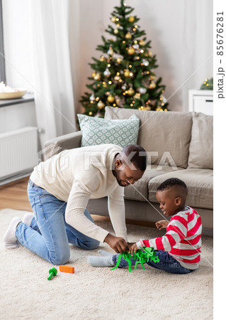 happy father playing with son on christmas at home happy father playing with son on christmas at home 85676281
