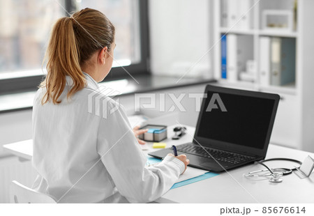 female doctor with laptop at hospital 85676614