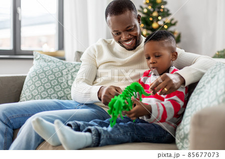 happy father playing with son on christmas at home happy father playing with son on christmas at home 85677073