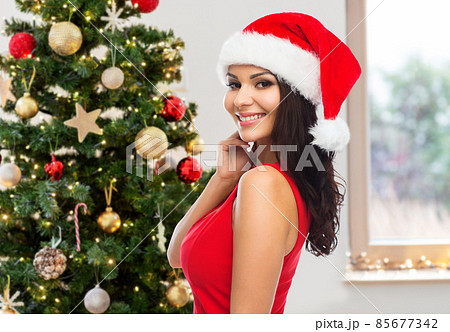 beautiful woman in red dress over christmas tree beautiful woman in red dress over christmas tree 85677342