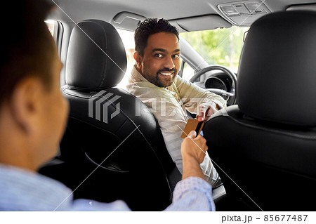 taxi car driver taking credit card from passenger 85677487