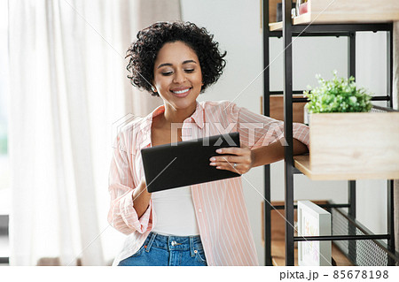 smiling woman with tablet pc computer at home smiling woman with tablet pc computer at home 85678198