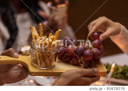 close up of people share food at dinner party 85678276