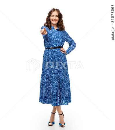happy young woman in blue dress pointing to camera happy young woman in blue dress pointing to camera 85678668