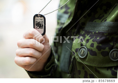 close up of young soldier with qr code on dog tag close up of young soldier with qr code on dog tag 85678669