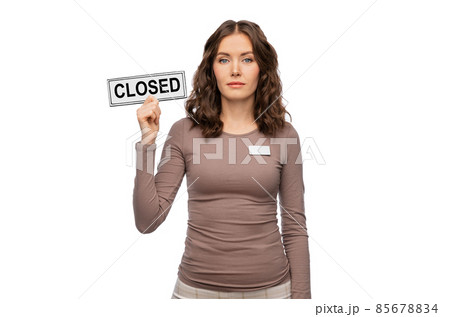 female shop assistant with closed sign 85678834