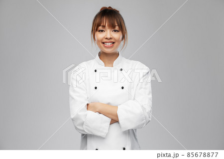 smiling female chef in white jacket smiling female chef in white jacket 85678877