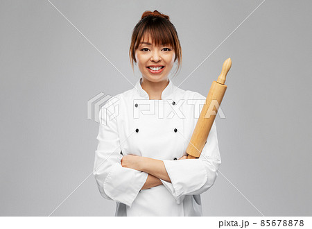smiling female chef or baker with rolling pin smiling female chef or baker with rolling pin 85678878