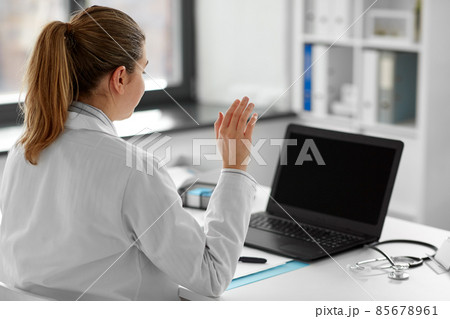 doctor with laptop having video call at hospital doctor with laptop having video call at hospital 85678961