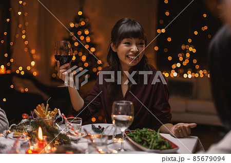 happy woman drinking red wine at christmas party happy woman drinking red wine at christmas party 85679094