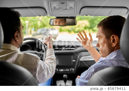 car driving school instructor teaching male driver car driving school instructor teaching male driver 85679411
