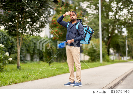 tired indian delivery man with bag in city tired indian delivery man with bag in city 85679446