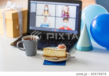 birthday cake and laptop with video call on screen birthday cake and laptop with video call on screen 85679878