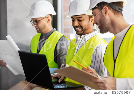 male architects in helmets working at office 85679907