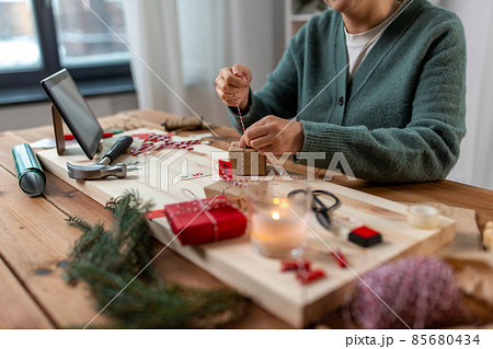 woman making advent calendar on christmas at home woman making advent calendar on christmas at home 85680434