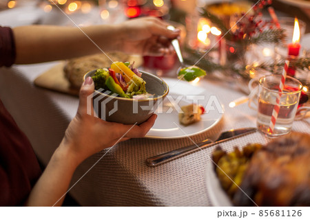 female hands with food at christmas dinner female hands with food at christmas dinner 85681126