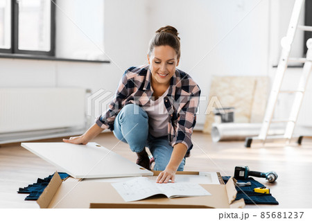woman with manual assembling new furniture at home 85681237