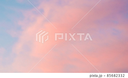 Background of blue sky with pale pink clouds in sunset Background of blue sky with pale pink clouds in sunset 85682332