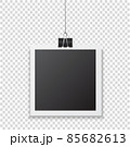 Photo frame with shadow hanging with paper clip. Black square snapshot and metal blinder.  85682613