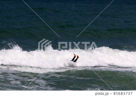 Surfing big waves in the Mediterranean Sea off the northern coast of Israel 85683737
