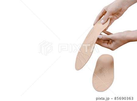 Orthopedic insole isolated on a white background. Medical insoles. Treatment and prevention of flat feet and foot diseases. Foot care, feet comfort. Wear comfortable shoes. Flat Feet Correction. Orthopedic insole isolated on a white background. Medical insoles. Treatment and prevention of flat feet and foot diseases. Foot care, feet comfort. Wear comfortable shoes. Flat Feet Correction. 85690363
