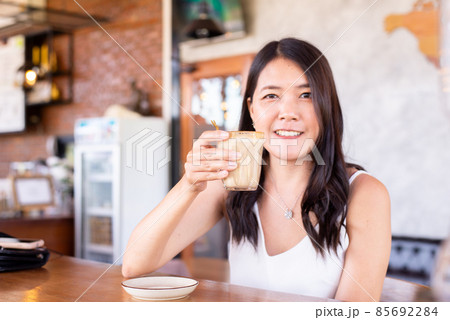 Beautiful asian woman drinking coffee in modern cafe,Take a coffee break 85692284