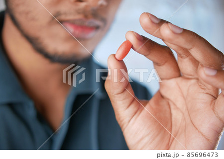 upset man hand holding medical pills upset man hand holding medical pills 85696473