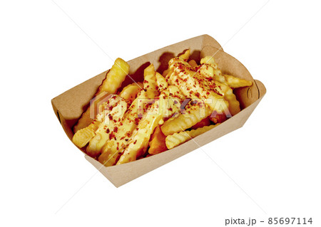 French fries in cardboard container with cheese sauce and fried bacon crumbs French fries in cardboard container with cheese sauce and fried bacon crumbs 85697114