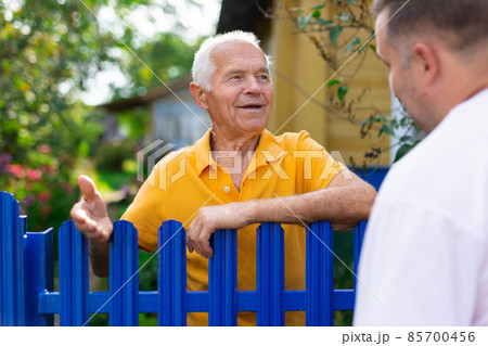Old man talking with his neighbour Old man talking with his neighbour 85700456
