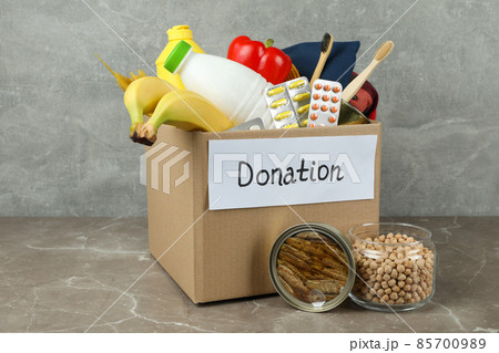 Concept of donate with donation box on gray textured table 85700989
