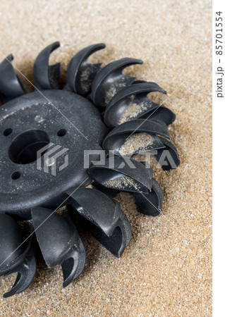 Plastic Pelton water turbine on sand with out water Plastic Pelton water turbine on sand with out water 85701554