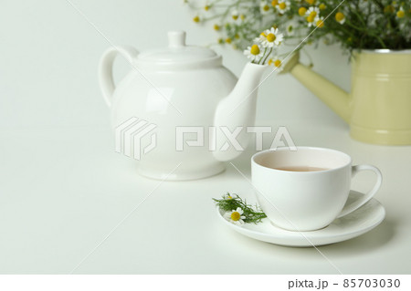 Concept of breakfast with chamomile tea on white table Concept of breakfast with chamomile tea on white table 85703030