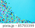Multicolored stars on a blue paper background. Festive background. 85703399