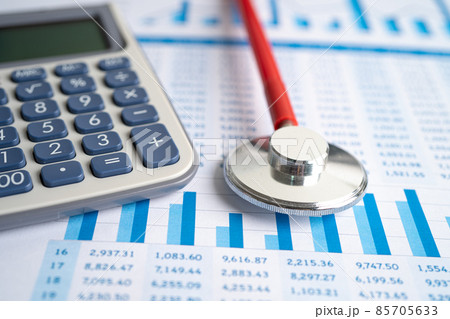 Stethoscope and calculator on charts and graphs paper, Finance, Account, Statistics, Investment, Analytic research data economy and Business company concept. 85705633