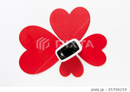 Covid Valentine day gift concept, pulse oximeter among flower from red hearts on white top view Covid Valentine day gift concept, pulse oximeter among flower from red hearts on white top view 85706259
