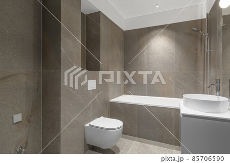 Modern minimalist bathroom beige interior design with marble tiles and beige furniture. Modern minimalist bathroom beige interior design with marble tiles and beige furniture. 85706590