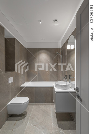 Modern minimalist bathroom beige interior design with marble tiles and beige furniture. 85706591