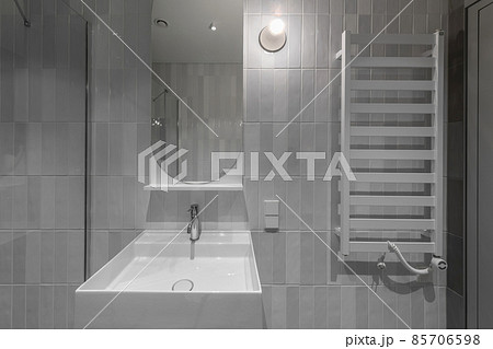 Modern furnished minimalist bathroom light grey interior design with metro style grey tiles Modern furnished minimalist bathroom light grey interior design with metro style grey tiles 85706598