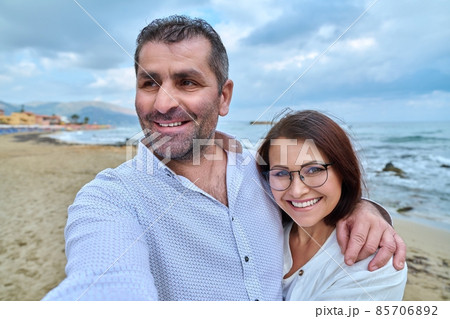 Happy mature couple taking selfie photo on smartphone. Happy mature couple taking selfie photo on smartphone. 85706892