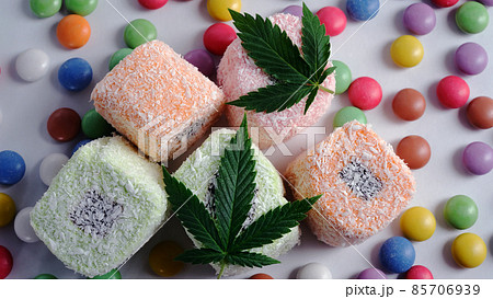 Colorful candy confetti with cannabis leaves, top view 85706939