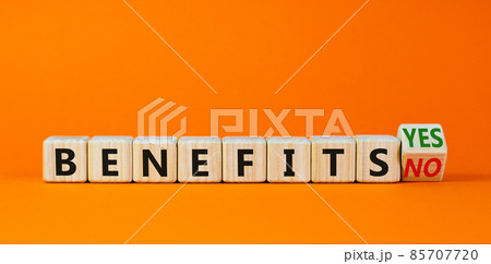 Benefits symbol. Turned a wooden cube and changed words 'benefits no' to 'benefits yes'. Beautiful orange background. Business and benefits concept, copy space. Benefits symbol. Turned a wooden cube and changed words 'benefits no' to 'benefits yes'. Beautiful orange background. Business and benefits concept, copy space. 85707720