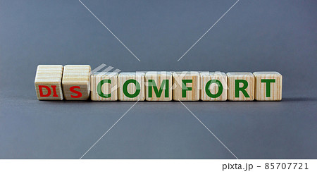 From discomfort to comfort symbol. Turned a cube and changed the word 'discomfort' to 'comfort'. Beautiful grey background, copy space. Business and from discomfort to comfort concept. 85707721
