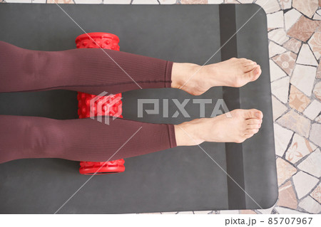 Young woman stretch body on fitness mat. Myofascial release massage 85707967