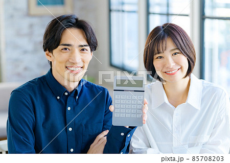 自宅でレシートを見ながら計算する若い夫婦の確定申告イメージ 自宅でレシートを見ながら計算する若い夫婦の確定申告イメージ 85708203