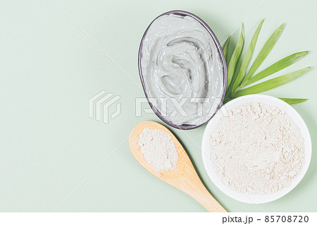 Cosmetic clay face mask in bowl next to dry powder 85708720