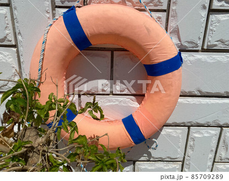 Lifebuoy on concrete wall background. Lifebuoy on concrete wall background. 85709289