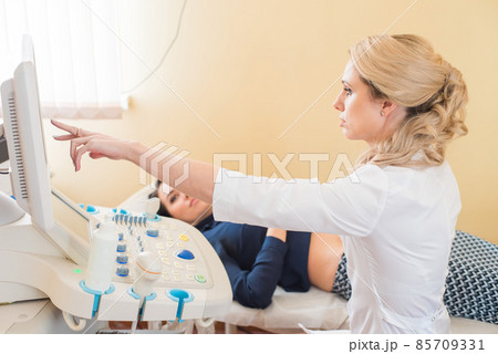 beautiful gynecologist examines the medical devices. The patient lies on the couch beautiful gynecologist examines the medical devices. The patient lies on the couch 85709331